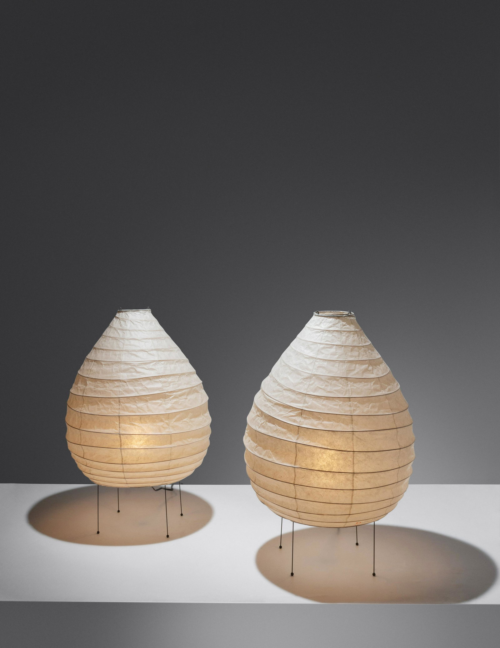 Isamu Noguchi (1904-1988) Pair of Akari Light Sculptures, model 22N Ozeki & Co., Ltd., USA/Japan: Isamu Noguchi (1904-1988) Pair of Akari Light Sculptures, model 22N Ozeki & Co., Ltd., USA/Japan washi paper, enameled steel, rubber with artist and manufacturer's stamps H 24 1/2 x Diameter 16 1/2 in