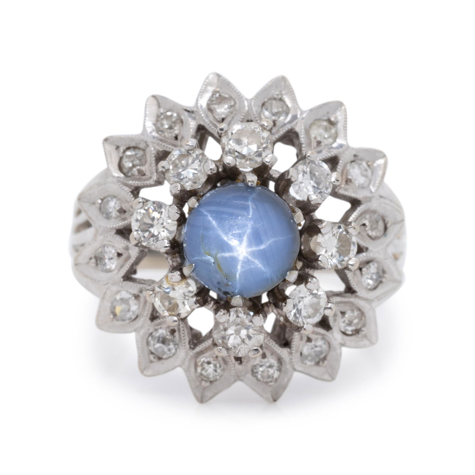 STAR SAPPHIRE AND DIAMOND RING: STAR SAPPHIRE AND DIAMOND RING Containing one round cabochon star sapphire measuring approximately 7.30 mm in diameter and 24 round brilliant cut diamonds weighing approximately 1.00 carat total. Moun