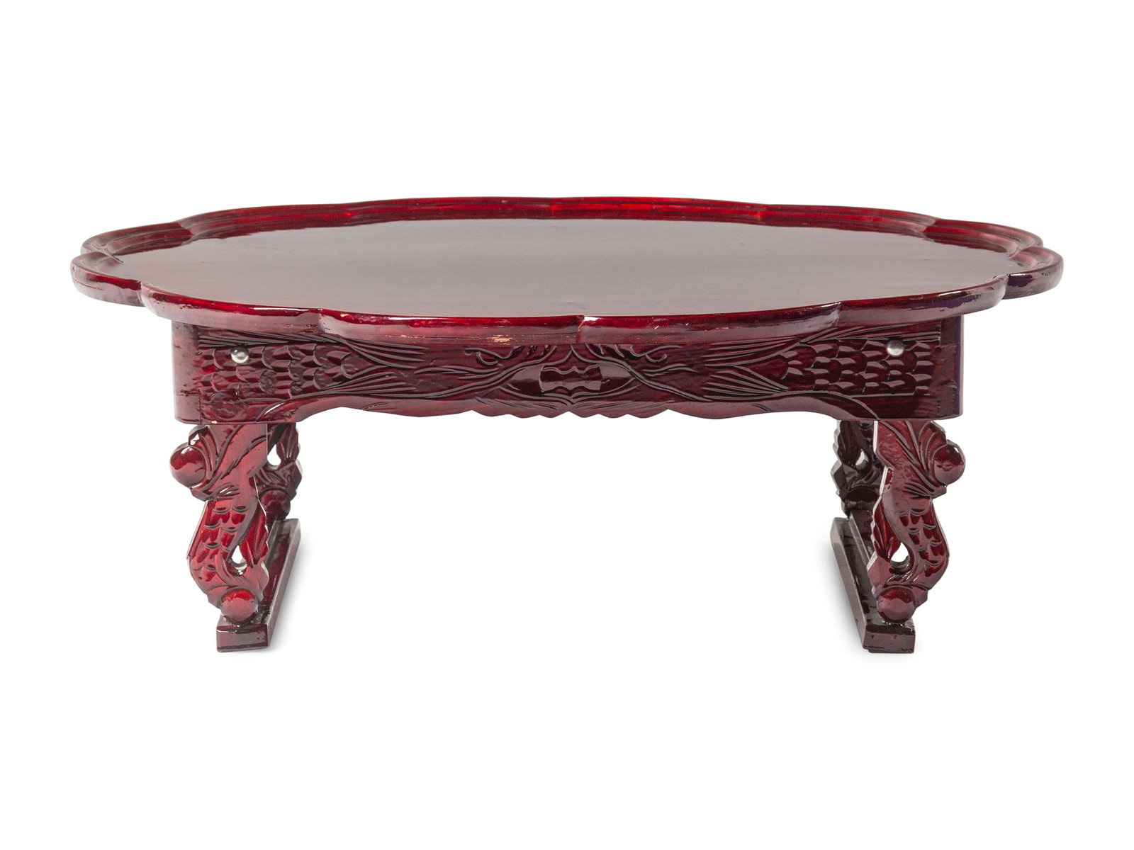 A Korean Carved Wood Flori-Form Tray: A Korean Carved Wood Flori-Form Tray set above a pair of hinging legs joined by stretchers, the whole varnished in a cherry tone. Diameter of tray 27 x height 10 in., 68.6 x 25.5 cm.
