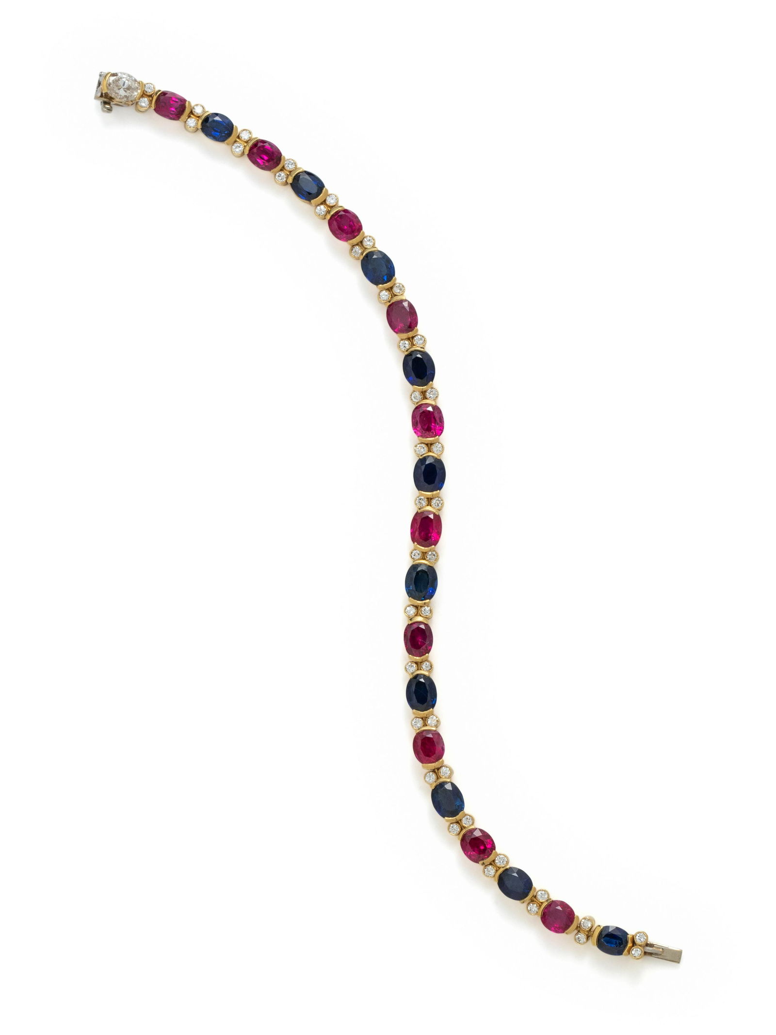 JULIUS COHEN, RUBY, SAPPHIRE AND DIAMOND BRACELET: JULIUS COHEN, RUBY, SAPPHIRE AND DIAMOND BRACELET Containing 10 oval mixed cut rubies and 10 oval mixed cut sapphires measuring approximately 5.50 x 4.60 mm and 42 round brilliant cut diamonds and one