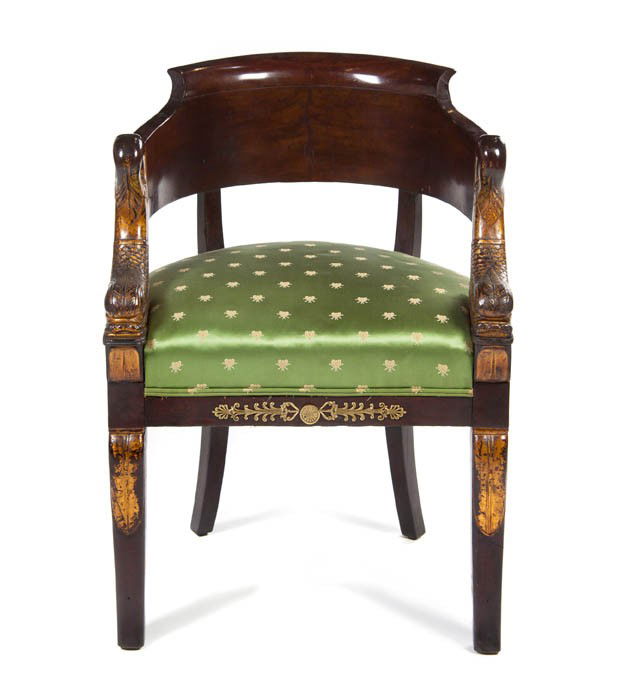 An Empire Mahogany, Parcel Gilt and Gilt Bronze Mo: An Empire Mahogany, Parcel Gilt and Gilt Bronze Mounted Fauteuil, having a rounded back and dolphin form arms over the upholstered seat, raised on sabre legs. Height 31 inches.