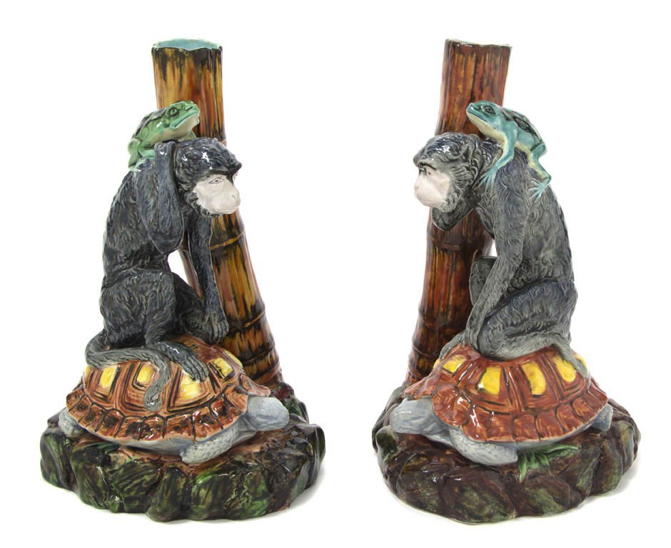 A Pair of English Ceramic Candlesticks, Worcester,: A Pair of English Ceramic Candlesticks, Worcester, each modeled as a frog seated on a monkey riding a turtle. Height 8 3/4 inches.