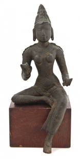 A Southeast Asian Bronze Figure of Parvati, Height: A Southeast Asian Bronze Figure of Parvati, likely Chola, depicted in a seated pose with conical headdress, with serene expression, the body draped with multiple necklaces and strands of beads and wea