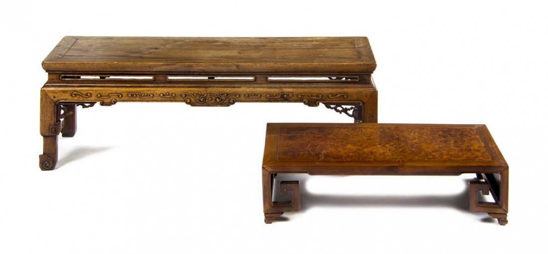 A Chinese Low Table, Height 12 x width 37 x depth: A Chinese Low Table, having a rectangular top over the pierce carved frieze, raised on short legs ending in scrolling toes, together with a smaller example. Height 12 x width 37 x depth 12 1/4 inches.