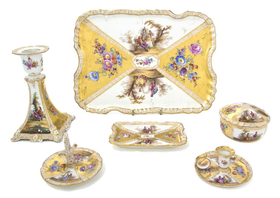 An Assembled Collection of Dresden Vanity Article: An Assembled Collection of Dresden Vanity Articles, comprising two trays, a powder box, a candlestick, a ring tray and a diminutive chamberstick. Height of tallest 5 7/8 inches.