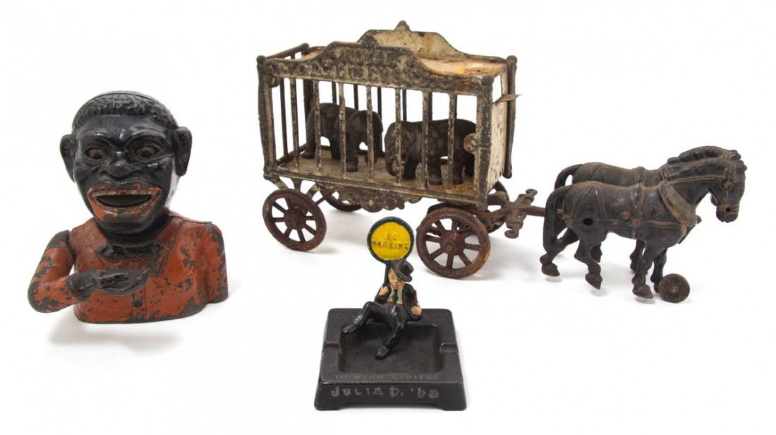 A Cast Iron Model of a Circus Cart, Length of fir: A Cast Iron Model of a Circus Cart, together with a cast iron mechanical bank and a cast iron ash receiver. Length of first 15 3/4 inches.