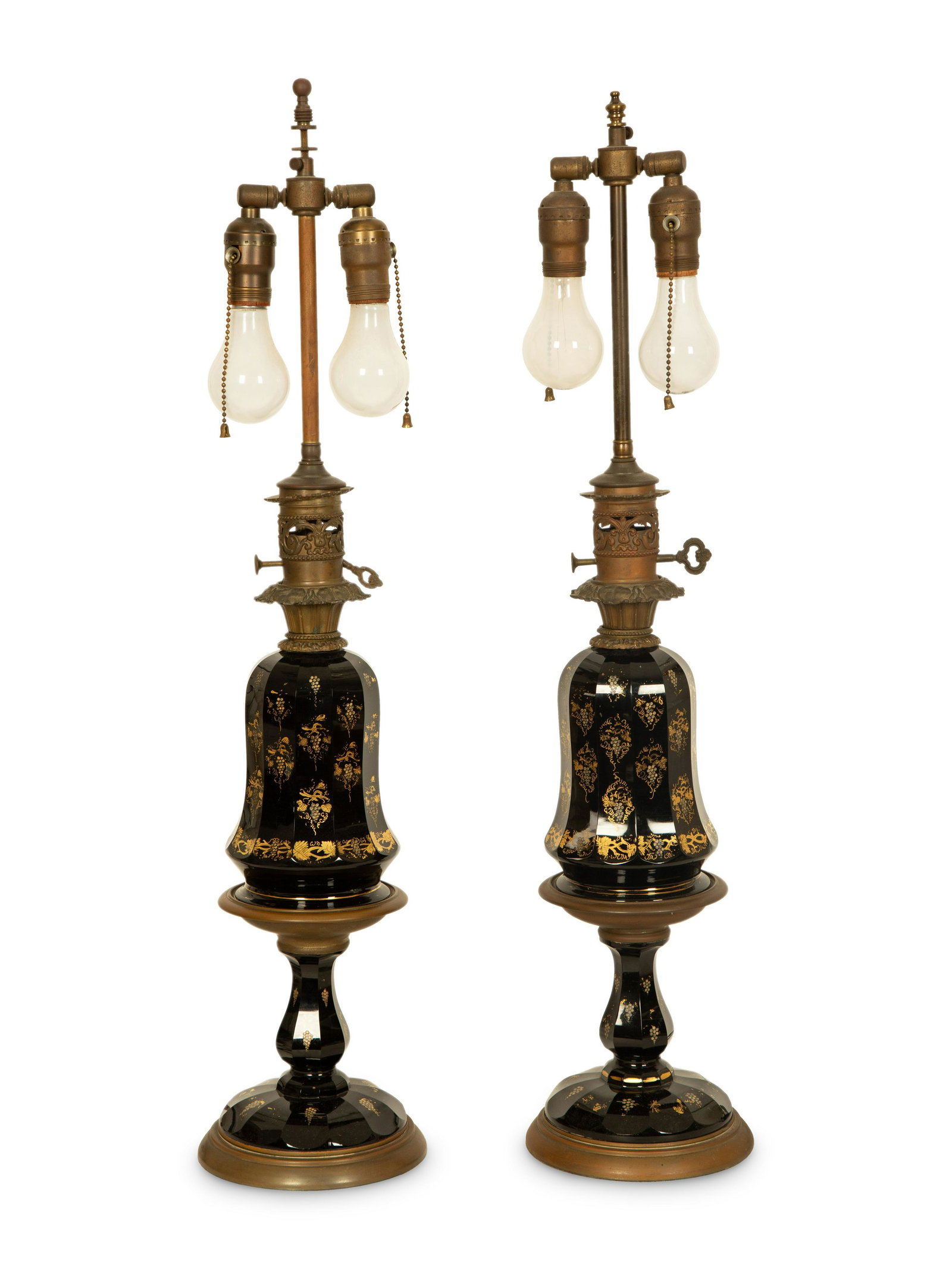 A Pair of Gilt Decorated Black Glass and Gilt Metal Oil Lamps : A Pair of Gilt Decorated Black Glass and Gilt Metal Oil Lamps 19th/20th Century convereted to electricity.Height overall 31 1/2 inches. Property from the Collection of Frances G. Scaife