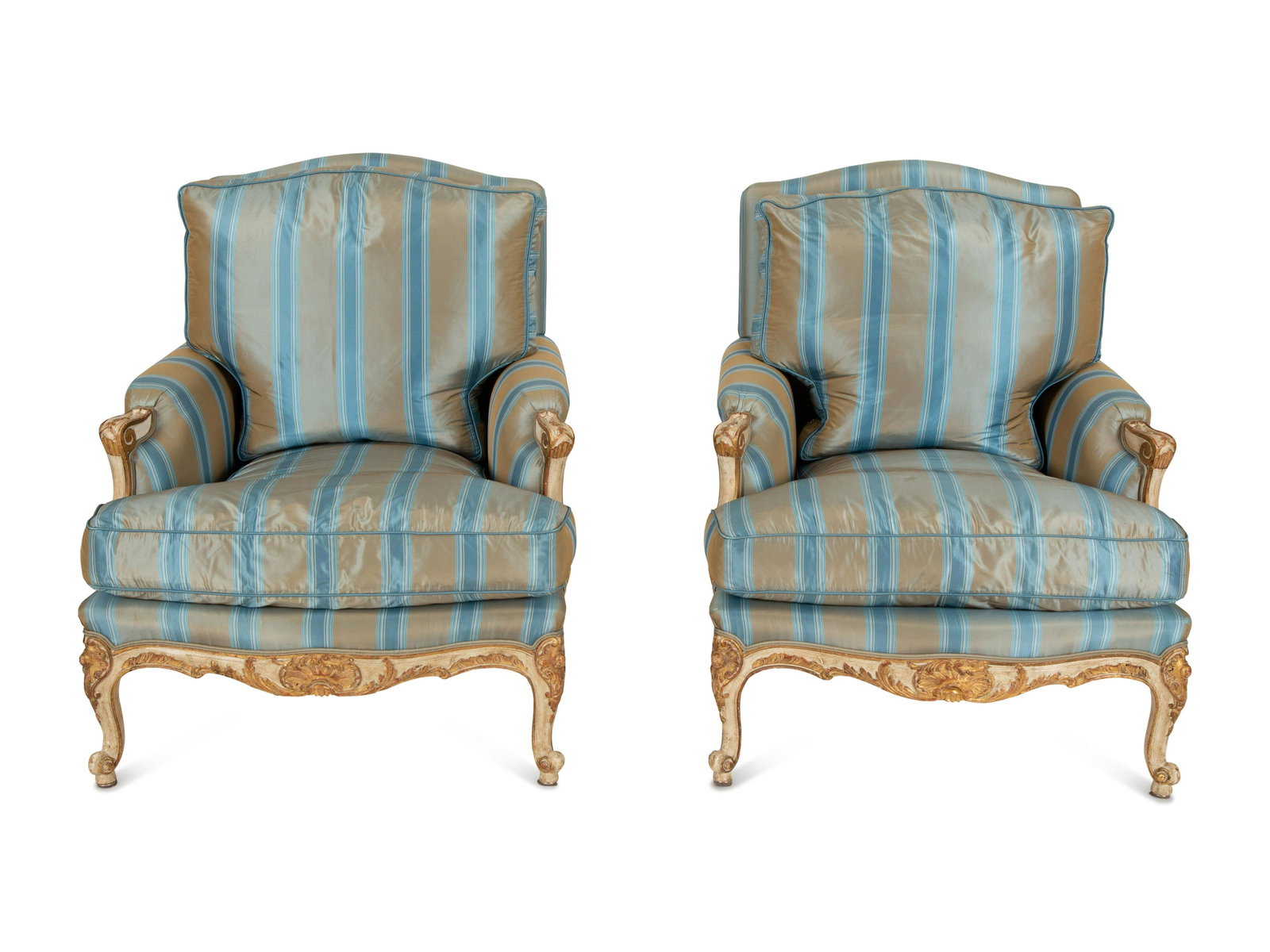 A Pair of Louis XV Style Painted and Parcel Gilt Bergeres: A Pair of Louis XV Style Painted and Parcel Gilt Bergeres upholstered in striped silk.Height 37 x width 31 x depth 30 inches.