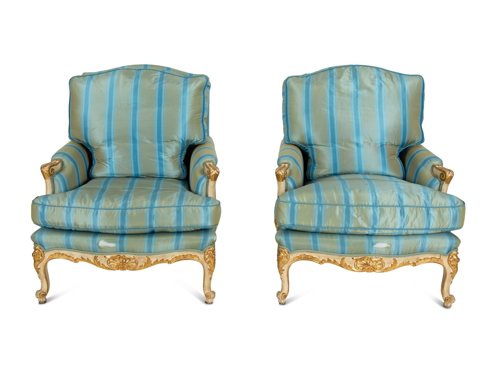 A Pair of Louis XV Style Painted and Parcel Gilt Bergeres: A Pair of Louis XV Style Painted and Parcel Gilt Bergeres 19th Century upholstered in striped silk.Height 37 x width 31 x depth 30 inches.