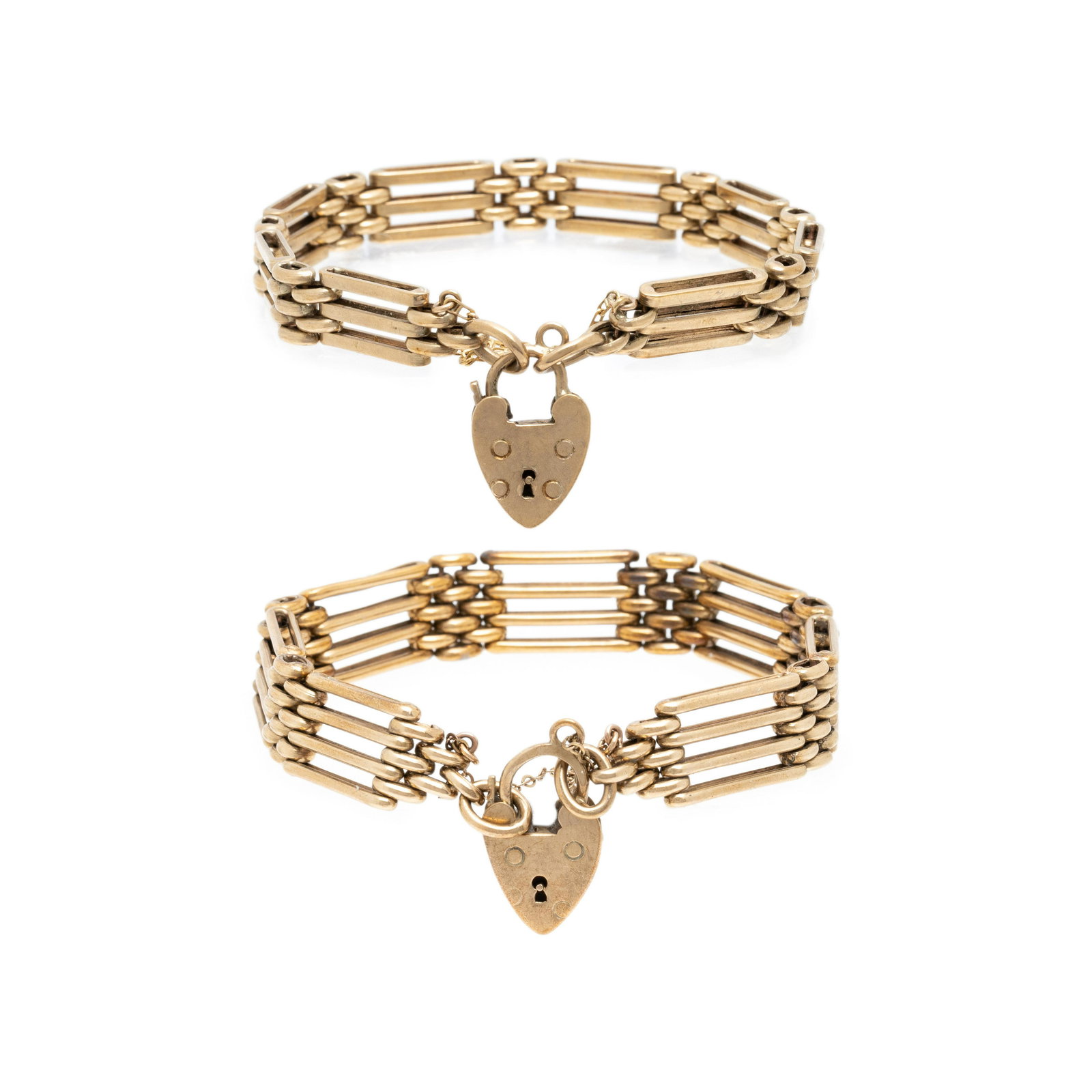 VICTORIAN, YELLOW GOLD BRACELET SET: VICTORIAN, YELLOW GOLD BRACELET SET Consisting of two fancy link bracelets with heart padlock motif clasps. 6 7/8 inches inner circumference.Stamp: S.J.R. (British hallmarks for 9 karat gold).Gross we