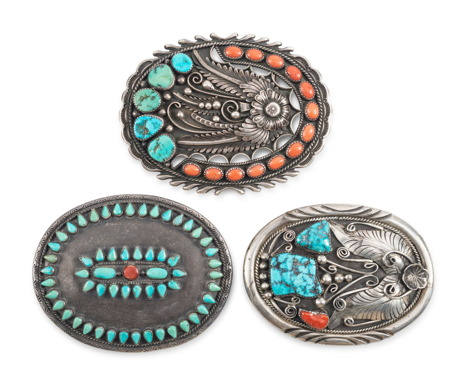 Navajo Silver, Turquoise, and Coral Belt Buckles: Navajo Silver, Turquoise, and Coral Belt Buckles third quarter 20th century lot of 3, includes; an ovular buckle set with an outer row of coral and turquoise, housing a scrolling floral silver appliqu