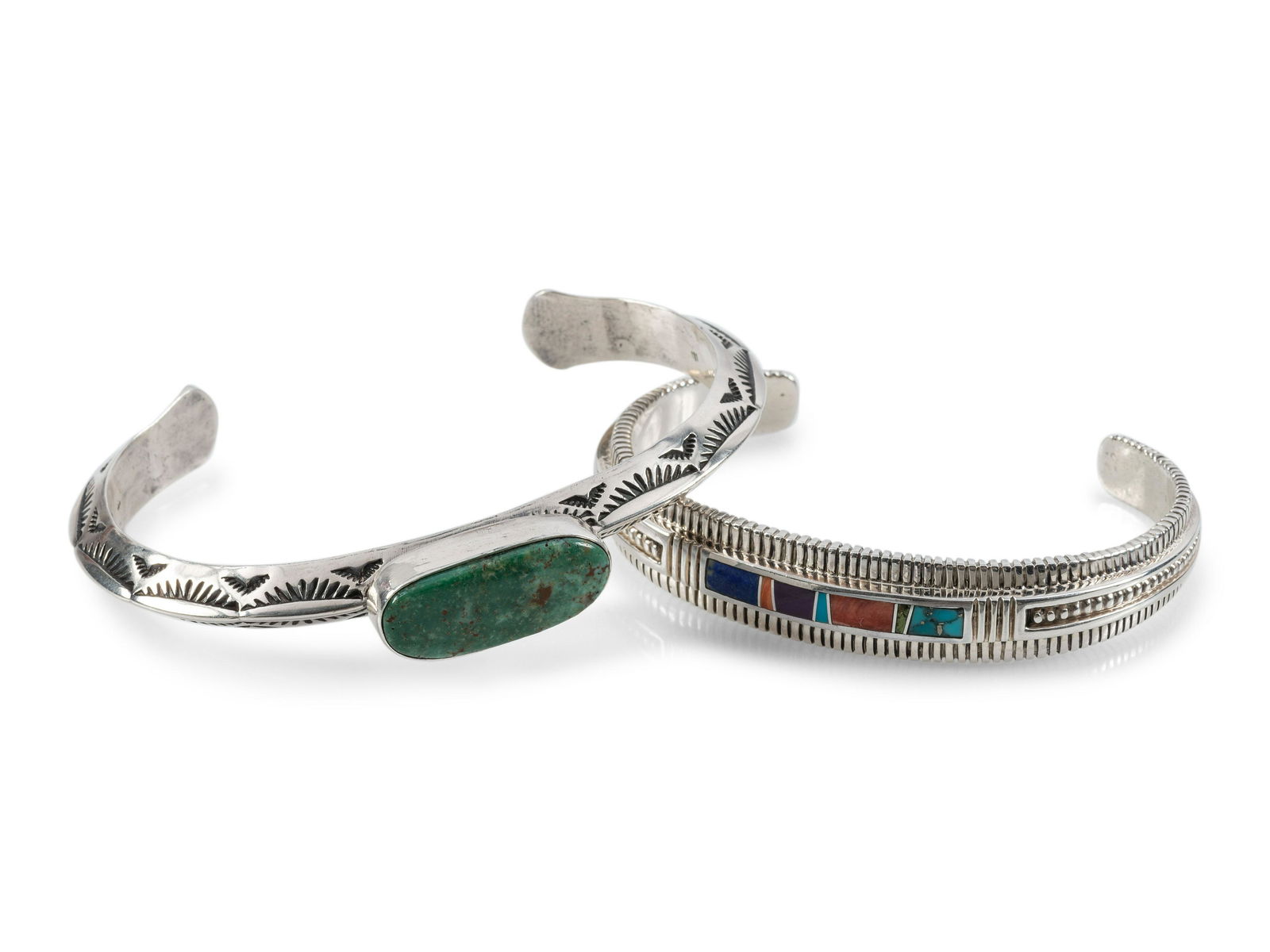 Navajo Slender Sterling Silver Cuff Bracelets, with Inlay: Navajo Slender Sterling Silver Cuff Bracelets, with Inlay late 20th century lot of 2, includes: heavily stamped beveled cuff, set with a single turquoise cabochon; marked STERLING SILVER HAND MAD