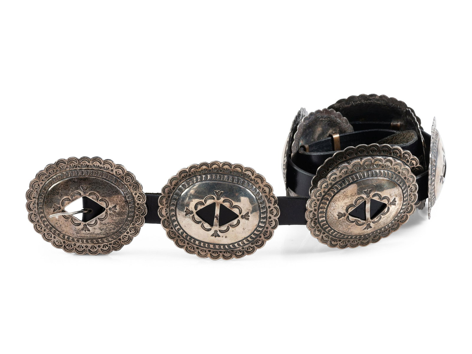 Navajo Stamped Silver Concha Belt: Navajo Stamped Silver Concha Belt mid - third quarter 20th century eight conchas and matching buckle; not marked concha and buckle length 3-1/2 inches x width 3 inches, belt length 45-3/4 inches, tota
