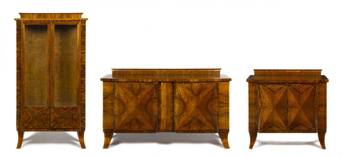 An Art Deco Walnut Three Piece Dining Room Suite, He: An Art Deco Walnut Three Piece Dining Room Suite, comprising a server, a sideboard and a vitrine cabinet, together with an associated dining table. Height of vitrine 69 x width 35 1/4 x depth 15 inche