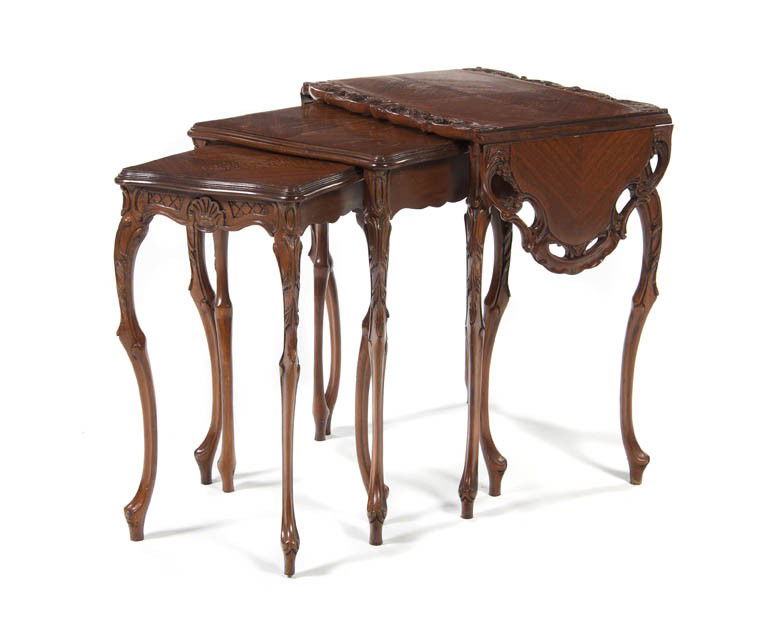 A Set of Three Rococo Style Nesting Tables, Height: A Set of Three Rococo Style Nesting Tables, each having a rectangular top, the largest having pierce carved edges and drop-leaves which extends to form a cartouche form top, raised on foliate carved c