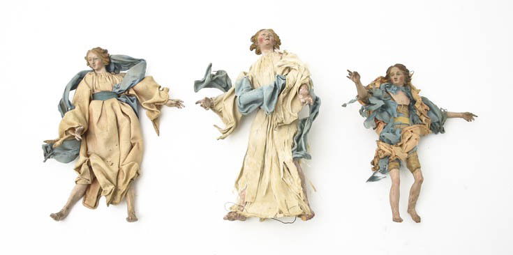A Group of Three Creche Figures, Height of tallest: A Group of Three Creche Figures, each depicting an angel with her arms spread in flowing robes and a blue sash. Height of tallest 9 inches.