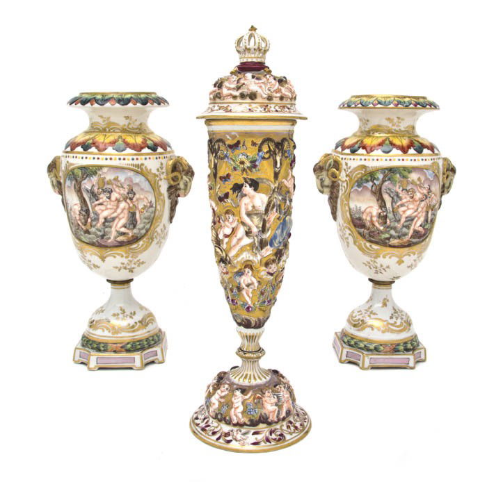 A Pair of Capodimonte Urns, Height 12 3/4 inches.: A Pair of Capodimonte Urns, together with a lidded urn decorated with putti, rams and a crown finial. Height 12 3/4 inches.