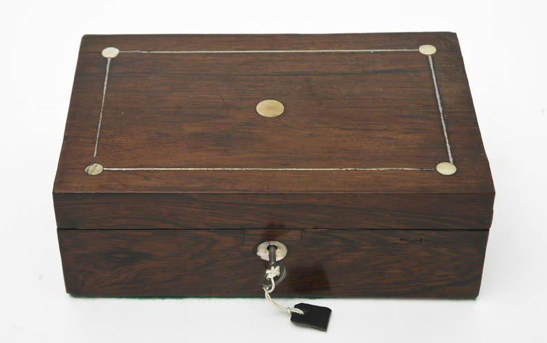 A Rosewood Jewelry Casket, Height 3 x width 8 3/4 : A Rosewood Jewelry Casket, having a rectangular line and mother-of-pearl inlaid top opening to a later fitted interior. Height 3 x width 8 3/4 inches x depth 5 1/2 inches.