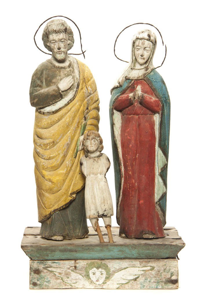 A Carved and Polychrome Decorated Santos Figural G: A Carved and Polychrome Decorated Santos Figural Group, depicting the Holy Family, set on an angel decorated base. Height 16 1/2 inches.