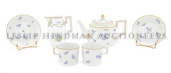 An Assembled Continental Porcelain Tete-a-Tete, He: An Assembled Continental Porcelain Tete-a-Tete, comprising a teapot, two teacups with saucers and a creamer, each with floral decoration, the creamer having starred and dotted crossed swords mark in u