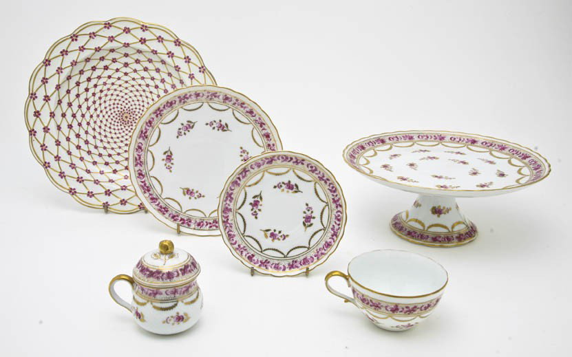 A Continental Porcelain Dessert Service, Diameter : A Continental Porcelain Dessert Service, each decorated with bands of pink roses, gilt leaves and swags, comprising a pedestal cake stand, eight dessert plates, eight teacups and saucers and eight lid
