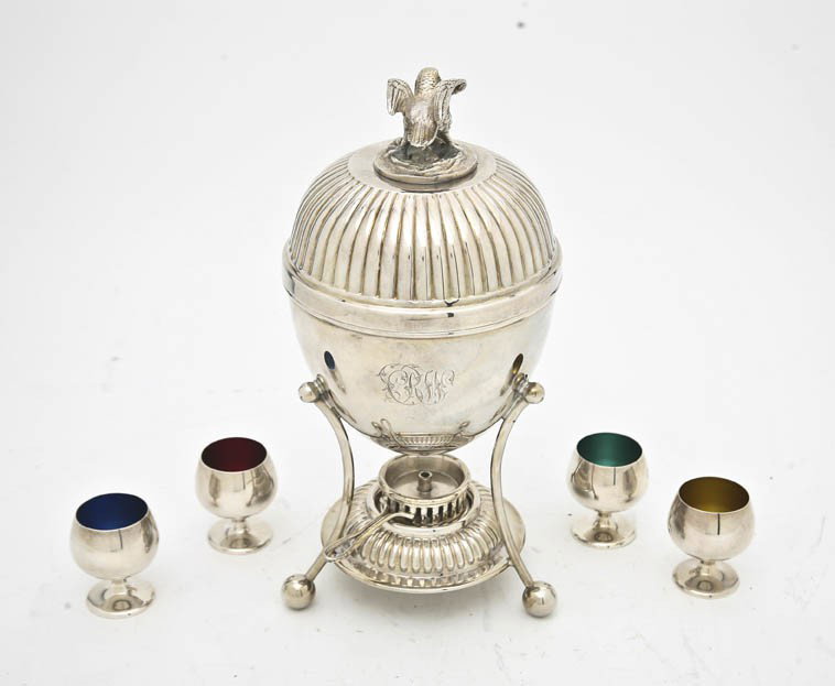 An English Sheffield Plate Egg Coddler, Walker & H: An English Sheffield Plate Egg Coddler, Walker & Hall, the domed lid surmounted by an eagle finial with a nest of eggs over the ovoid body and three bowed supports ending in ball feet, monogrammed, to