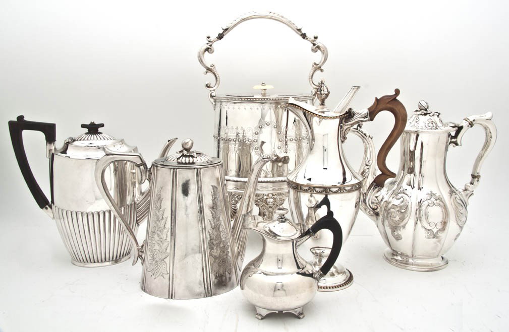 A Collection of Silverplate Articles, Height of ta: A Collection of Silverplate Articles, comprising a creamer, a chocolate pot, an ewer with a wood handle, two coffee pots, a kettle on stand and a warming dish on stand. Height of tallest 11 3/4 inches