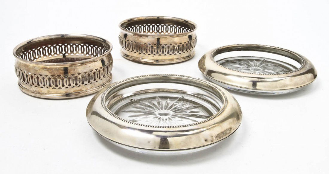 A Collection of Four Wine Coasters, Diameter of la: A Collection of Four Wine Coasters, comprising a pair of English silverplate coasters with pierced sides, turned wooden bases and baize lining and a pair of American sterling silver mounted wine holde