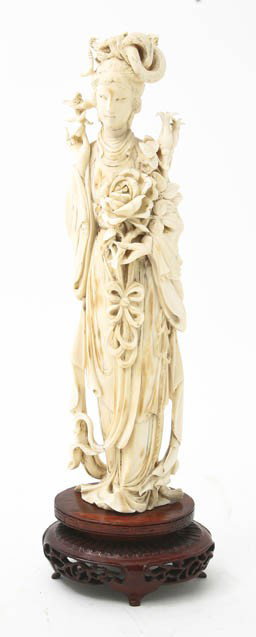An Ivory Model of a Lady, Height of ivory 10 1/8 i: An Ivory Model of a Lady, holding flowering branches, with flowing robes raised upon a wood base. Height of ivory 10 1/8 inches. Property of a Private West Michigan Collector