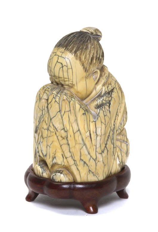 A Chinese Ivory Model of a Sleeping Lohan, Height: A Chinese Ivory Model of a Sleeping Lohan, the seated figure shown with knees tucked under his chin. Height 3 5/8 inches. Property from the Estate of Dr. Joseph and Donna Lee Boggs, Chicago, Illinois