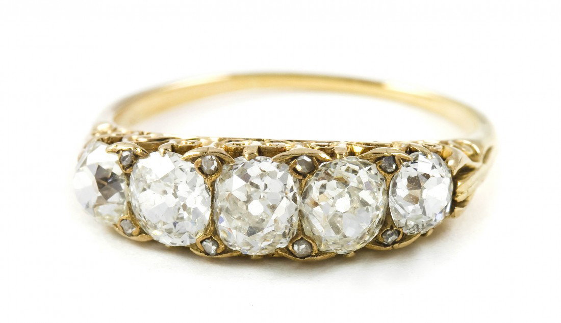 An Edwardian Yellow Gold and Diamond Ring, 1.85 dwt: An Edwardian Yellow Gold and Diamond Ring, containing five old mine cut diamonds weighing approximately 1.70 carats total, openwork gallery. 1.85 dwts.