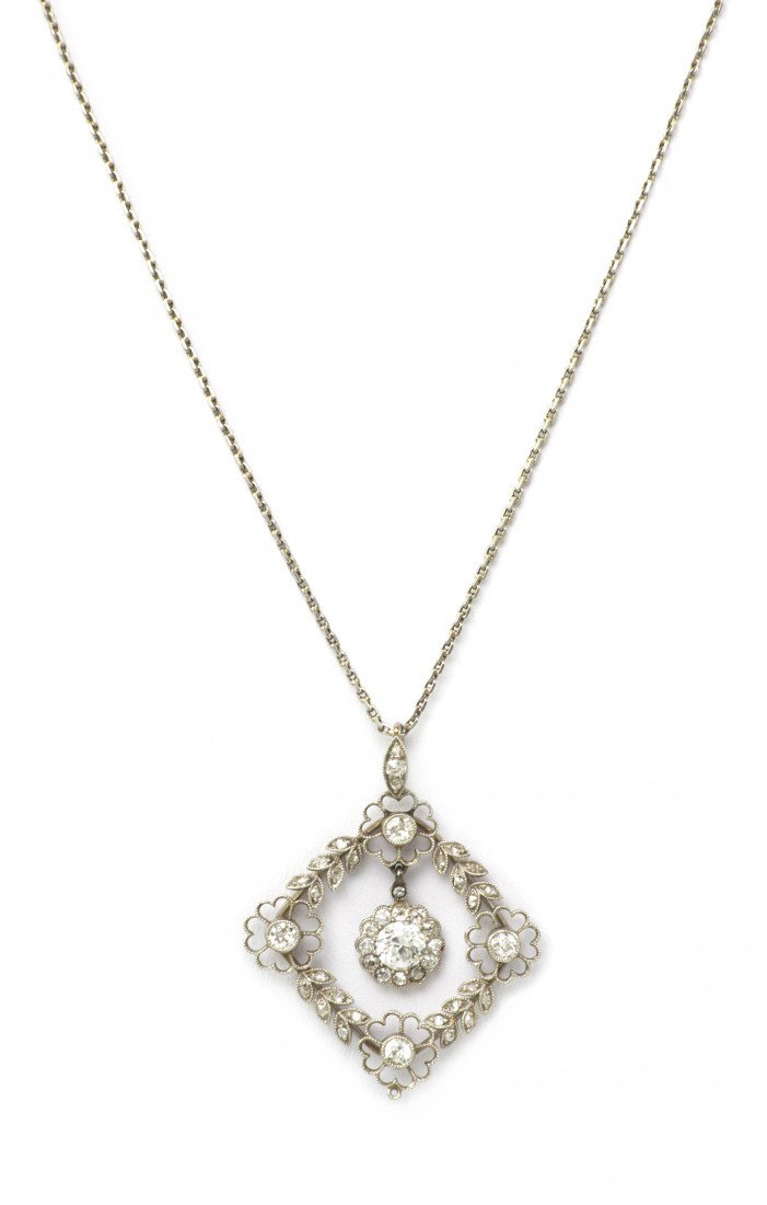 An Edwardian Platinum and Diamond Foliate Pendant, : An Edwardian Platinum and Diamond Foliate Pendant, in a compass set square openwork design with millegrain accents suspending a central flower shape setting, pendant contains numerous old European and