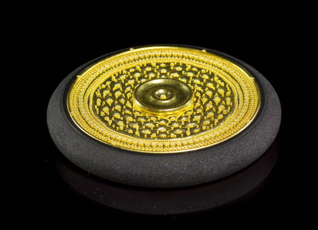 A Steel and 22 Karat Gold Table Object, Daniel Bru: A Steel and 22 Karat Gold Table Object, Daniel Brush, consisting of a steel disk with outer stone texture rim, one side accented with an intricate inlaid gold plaque measuring approximately 48.00 mm i