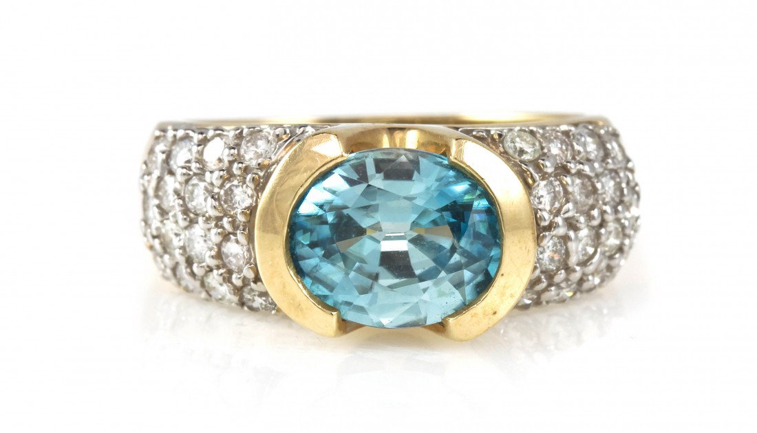 A 14 Karat Yellow Gold, Blue Zircon and Diamond Ri: A 14 Karat Yellow Gold, Blue Zircon and Diamond Ring, containing one oval brilliant cut blue zircon weighing approximately 3.30 carats and 30 round brilliant cut diamonds weighing approximately 0.60 c