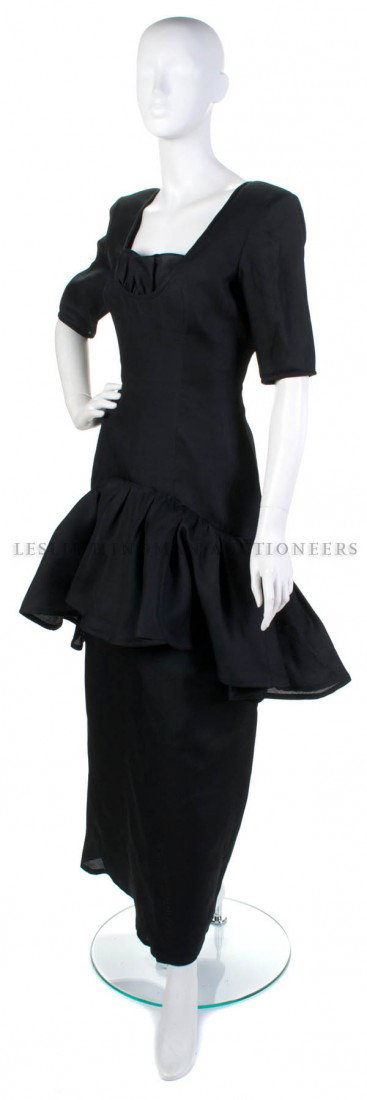 An Yves Saint Laurent Black Silk Gazar Evening Gow: An Yves Saint Laurent Black Silk Gazar Evening Gown, probably early 1990s, with a ruffle at neckline, flounce skirt. Labeled: Yves Saint Laurent. Size 40.