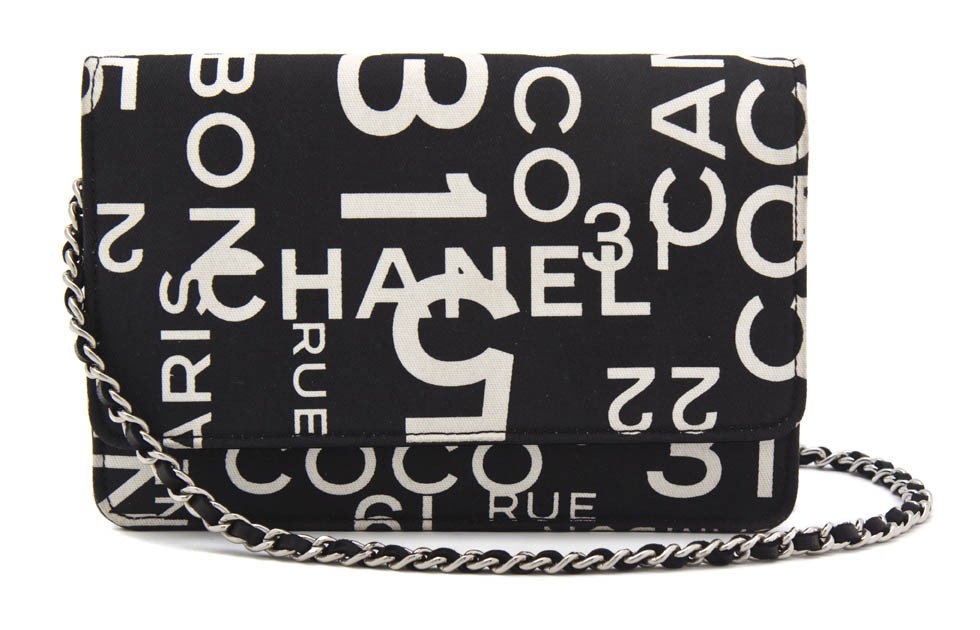 A Chanel Black and White Canvas 'Wallet on a Strin: A Chanel Black and White Canvas 'Wallet on a String' Bag. Stamped: Chanel. 7 1/2 x 5 inches.