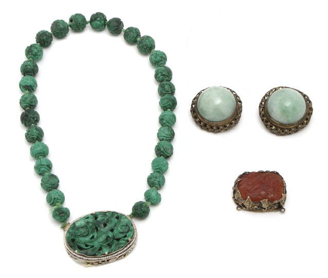 A Group of Carved Asian Decorative Objects, Length: A Group of Carved Asian Decorative Objects, comprising a silver mounted carved malachite beaded necklace, a double-sided carved agate pendant and a pair of metal mounted jadeite cabochons. Length of n