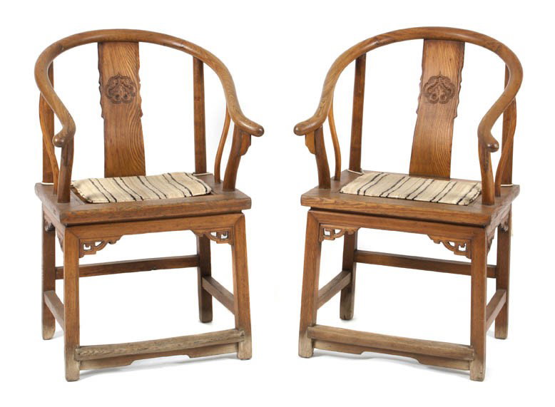A Pair of Chinese Elm Wood Yoke Back Armchairs, He: A Pair of Chinese Elm Wood Yoke Back Armchairs, each having a horseshoe form crest rail above a vertical splat with a carved medallion, the rectangular seats raised on squared legs. Height 38 inches.