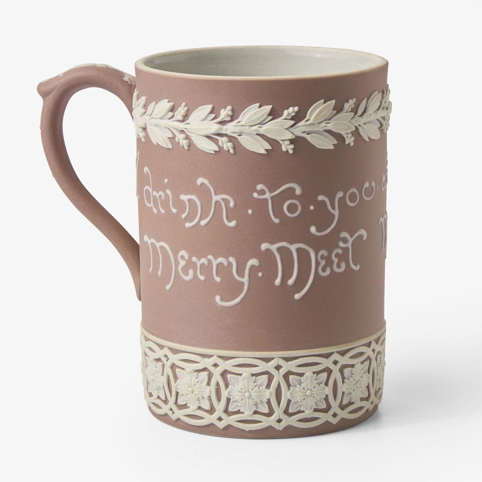 A Wedgwood Harry Barnard (1862-1933) Designed Lilac Dip Jasper Motto Mug UK, circa 1900: A Wedgwood Harry Barnard (1862-1933) Designed Lilac Dip Jasper Motto Mug UK, circa 1900 Stoneware Applied (sprigged) and sliptrailed decorationMotto reads, "I drink to you with all my heart merry meet
