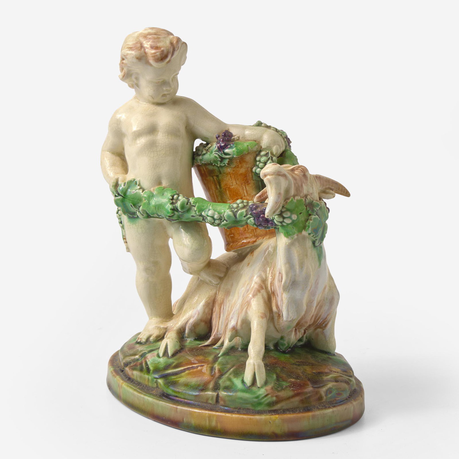 A Wedgwood Majolica Figural Group UK, 1880s: A Wedgwood Majolica Figural Group UK, 1880s Earthenware Representing a putto with goat, harvesting grapes. Impressed "WEDGWOOD" "AVQ" (date code for 1888) (H: 9, W: 7 1/2, D: 5 1/2 in.) Qty: (1)