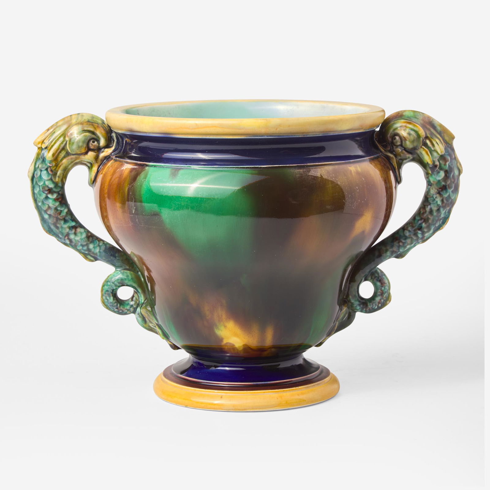 A Wedgwood Majolica Dolphin-Handled Jardiniere UK, 1869: A Wedgwood Majolica Dolphin-Handled Jardiniere UK, 1869 Glazed earthenwareShape 610. This form is shown in a pattern book page illustrating designs by Christopher Dresser, reproduced in Batkin. It is