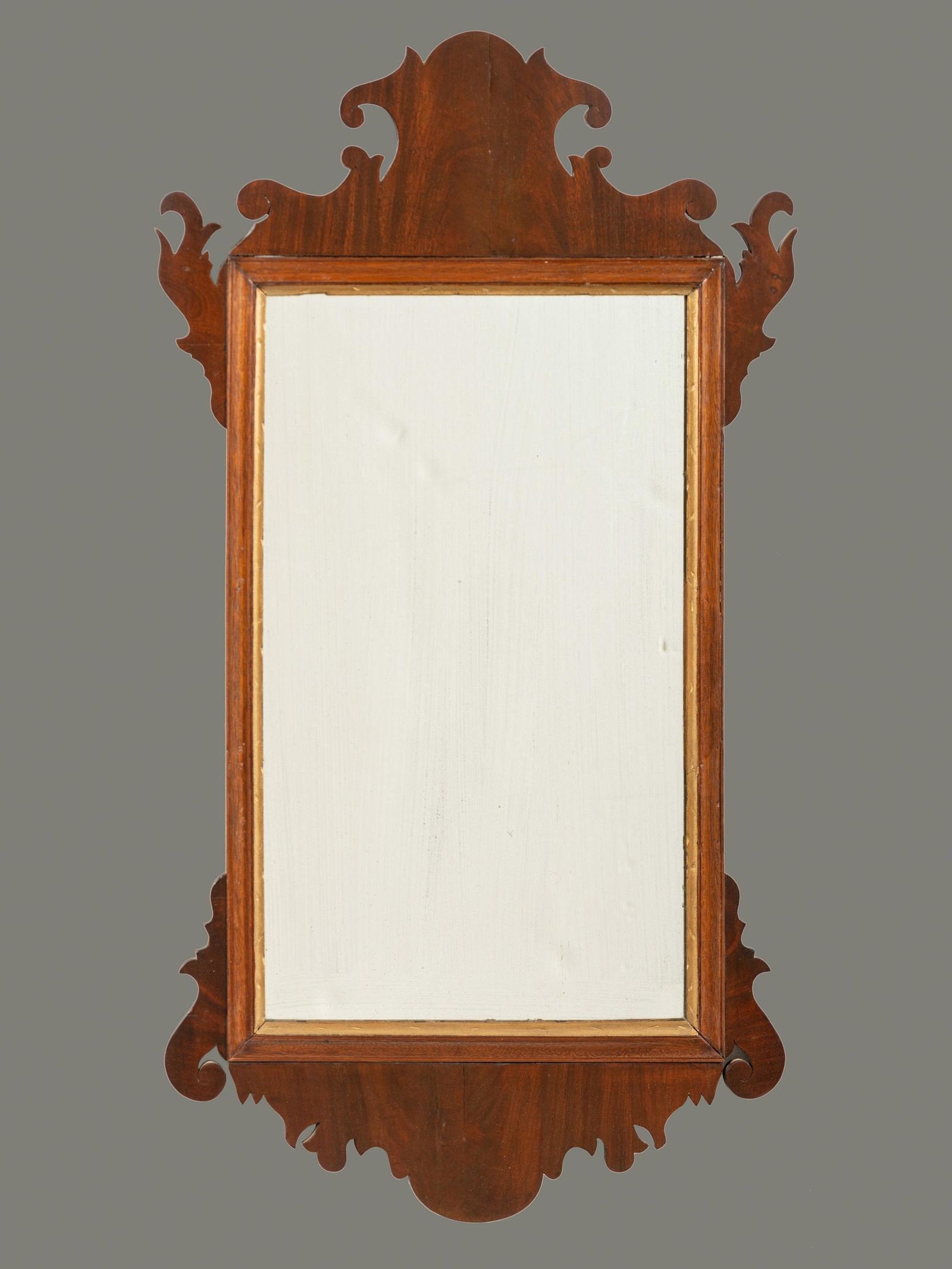 A Chippendale Carved Mahogany Looking Glass: A Chippendale Carved Mahogany Looking Glass New England, Circa 1800 35 3/4 x 19 inches. This lot is located in Cincinnati. Property from the Estate of Joanne Wojtusiak, Cornwall Bridge, Connecticut