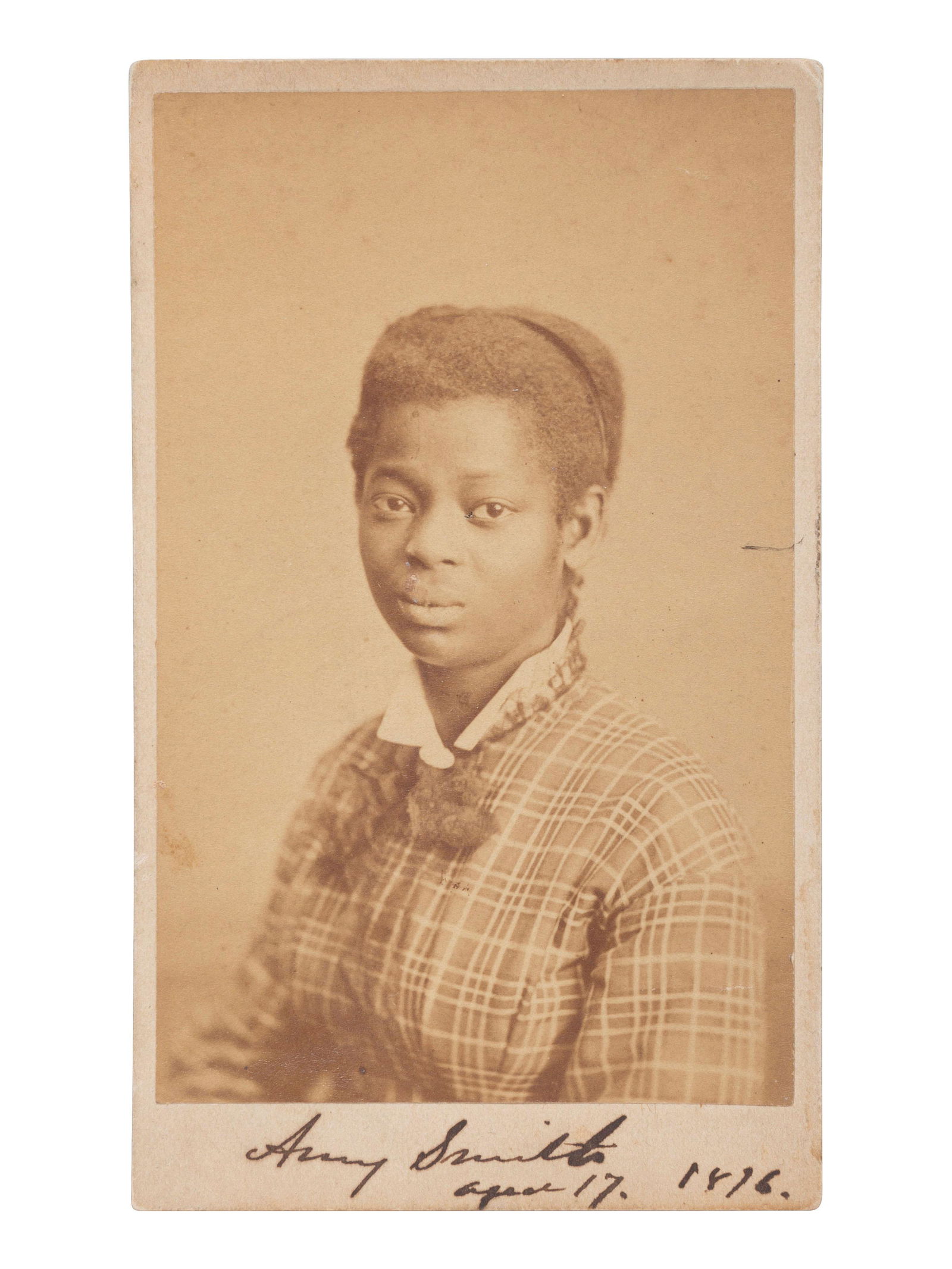 [EARLY PHOTOGRAPHY]. REIMER, B.F., photographer. CDV of identified African American woman, Amy: [EARLY PHOTOGRAPHY]. REIMER, B.F., photographer. CDV of identified African American woman, Amy Smith. Philadelphia, PA, [1876]. 2 1/4 x 3 5/8 in. CDV on cardstock mount (toning, light soiling/spotting