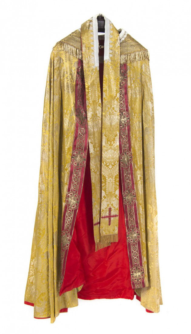 An Ecclesiastical Embroidered Cope, Benziger Broth: An Ecclesiastical Embroidered Cope, Benziger Brothers, the reverse having a circular cartouche depicting Jesus Christ highlighted with various stitches against a red ground, the whole decorated with k