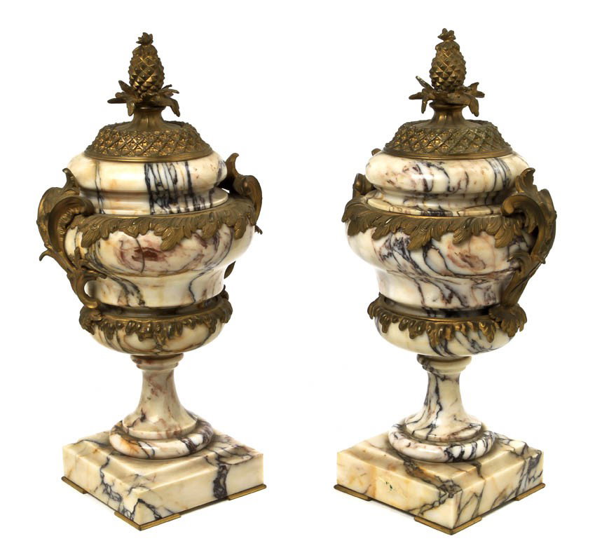 A Pair of Ormolu Mounted Marble Covered Urns, Heigh: A Pair of Ormolu Mounted Marble Covered Urns, surmounted with pine cone finials with opposing acanthus leaf handles, raised on stepped square bases with bracket feet. Height 16 1/2 inches.