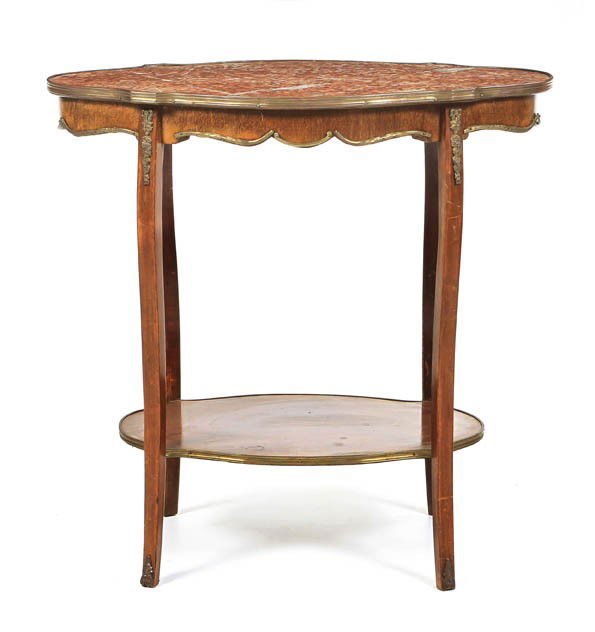 A Louis XVI Style Gilt Metal Mounted Occasional Ta: A Louis XVI Style Gilt Metal Mounted Occasional Table, having a shaped marble inset top, raised on tapering legs joined by a medial shelf. Height 28 x width 28 x depth 17 inches.