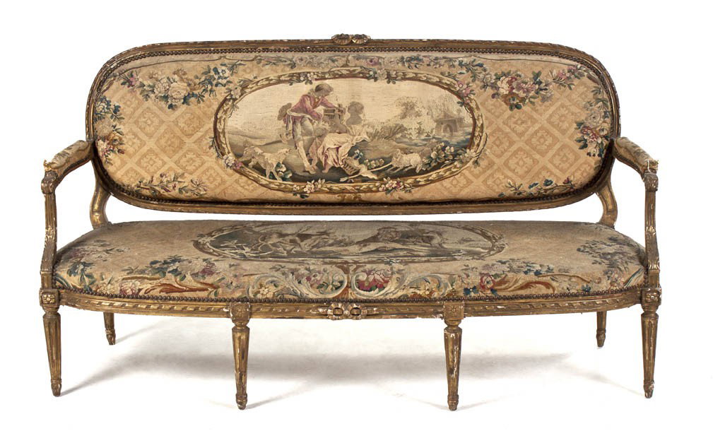 A Louis XVI Style Giltwood Canape, Width 68 inches: A Louis XVI Style Giltwood Canape, having a ribbon carved crest over the tapestry upholstered back, arms and seat, raised on tapering fluted legs. Width 68 inches.