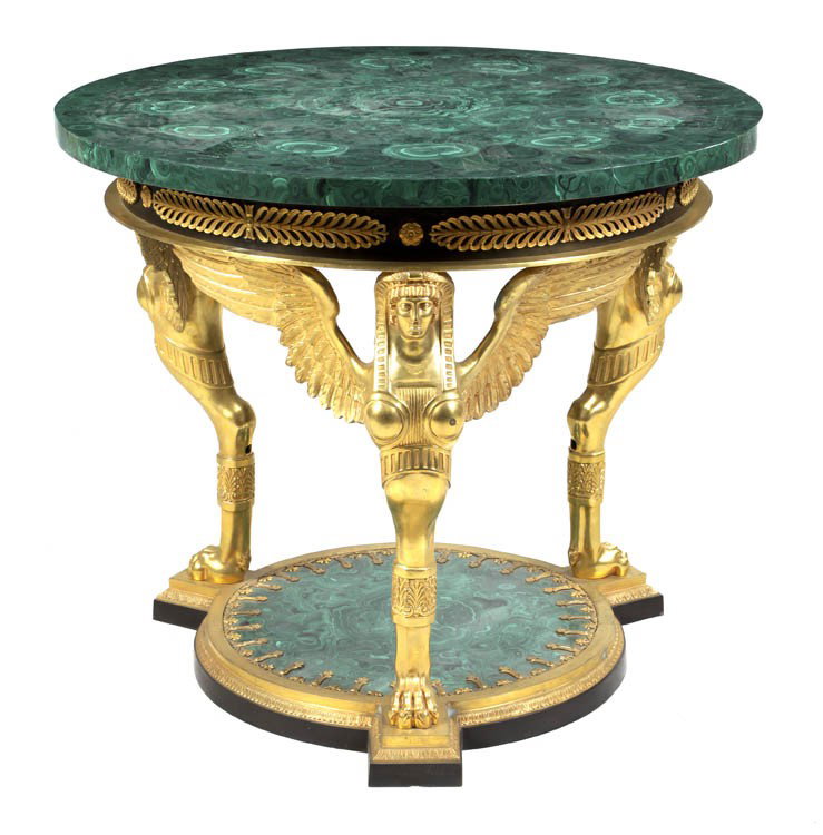 An Empire Style Gilt Bronze and Malachite Gueridon: An Empire Style Gilt Bronze and Malachite Gueridon, the circular top over the acanthus and rosette decorated frieze raised on three winged female monoped supports over the conforming plinth base. Heig