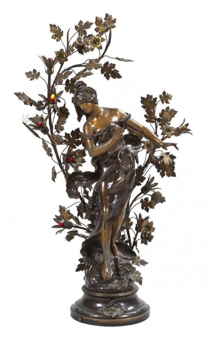 A Cast Metal Figural Newel Post Lamp, after Augus: A Cast Metal Figural Newel Post Lamp, after Auguste Moreau, cast as an Art Nouveau maiden amongst leafy branches. Height 50 1/2 inches.