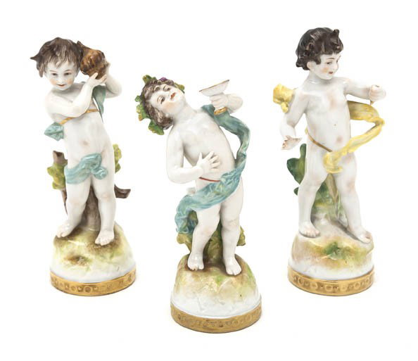 Three German Porcelain Figures, Height 6 1/4 inch: Three German Porcelain Figures, each depicting Bacchic putti raised on a circular gilt base. Height 6 1/4 inches.